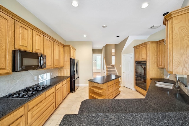 kitchen with sink, light tile patterned floors, tasteful backsplash, a kitchen island, and black appliances