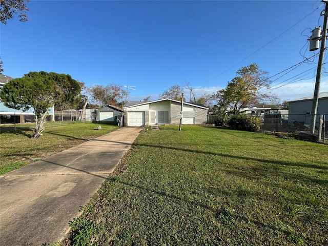 view of front of home with a front yard and a garage