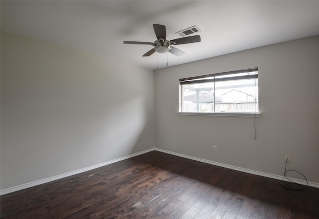 spare room with ceiling fan and dark hardwood / wood-style flooring