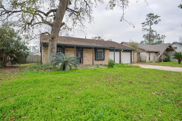 ranch-style house featuring a front lawn and a garage