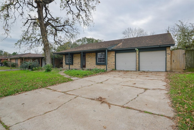 ranch-style home featuring a garage and a front lawn