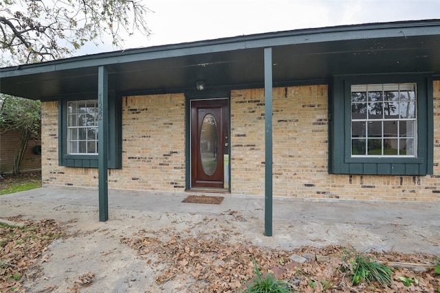 view of exterior entry featuring a porch