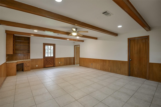 tiled spare room with ceiling fan and built in desk