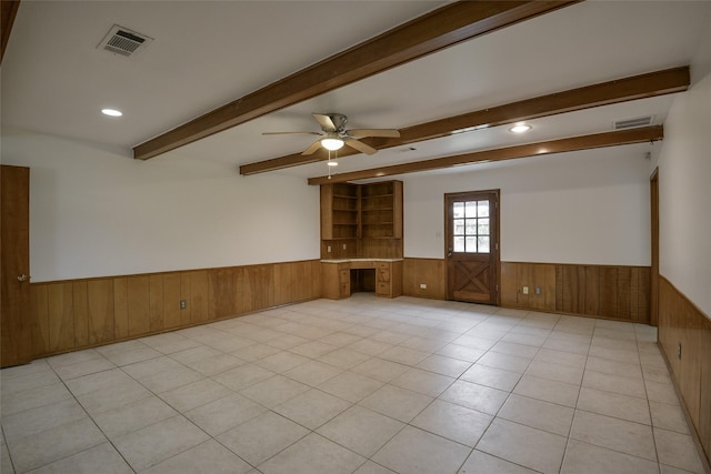 tiled empty room with built in desk and ceiling fan