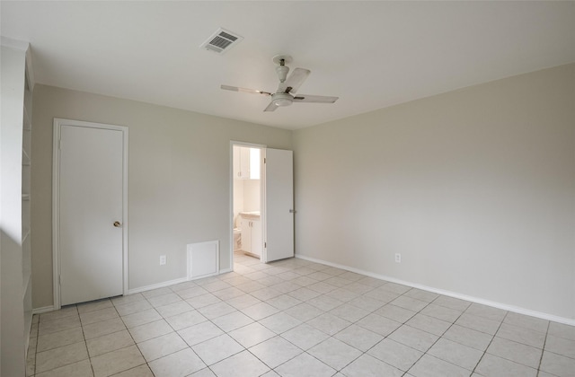 tiled spare room featuring ceiling fan