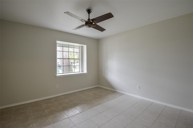 tiled spare room featuring ceiling fan