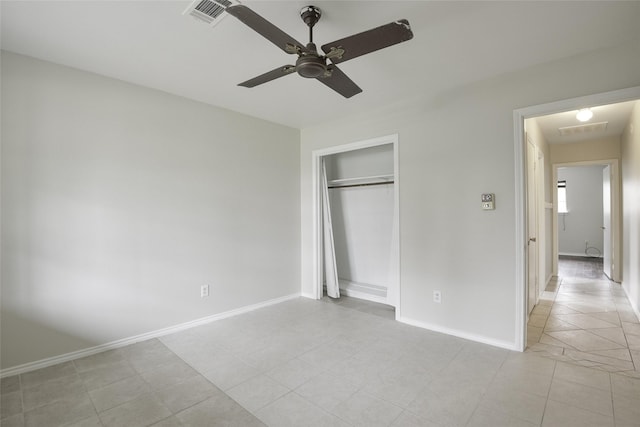 unfurnished bedroom with a closet, ceiling fan, and light tile patterned flooring