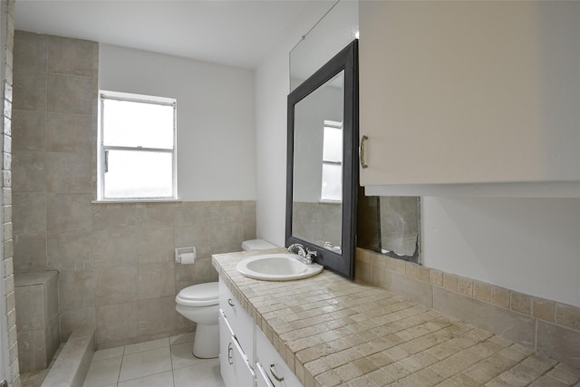 bathroom featuring tile patterned flooring, vanity, tile walls, and toilet