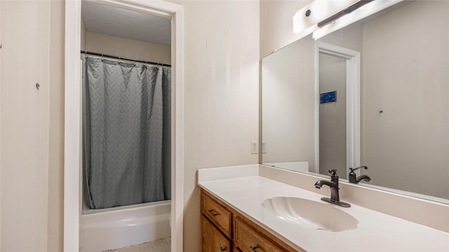 bathroom featuring a textured ceiling, vanity, and walk in shower