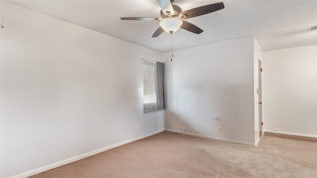 empty room featuring light carpet and ceiling fan