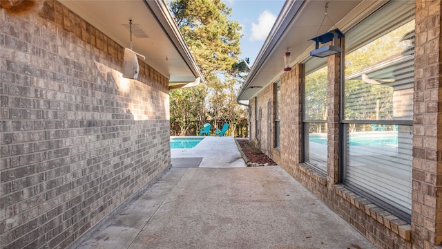 view of swimming pool featuring a patio area