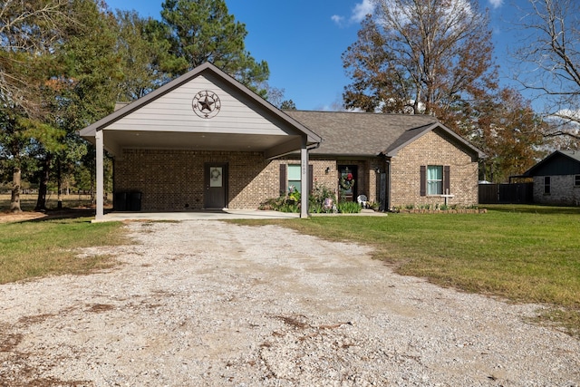 single story home featuring a front lawn and a carport