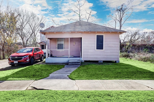 bungalow-style home featuring a porch and a front yard