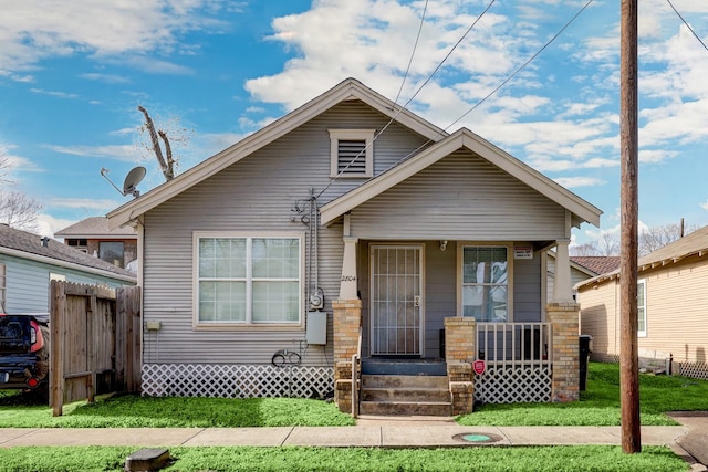 bungalow-style house with a front lawn and a porch