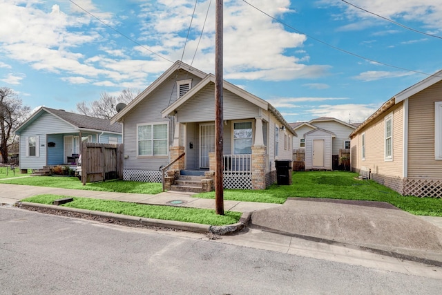 bungalow-style home featuring a storage shed and a front lawn