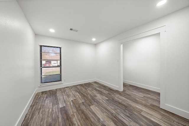 unfurnished room with dark hardwood / wood-style floors