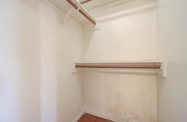 spacious closet featuring dark tile patterned floors