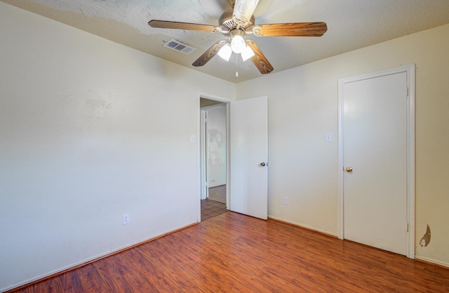 unfurnished bedroom with ceiling fan and hardwood / wood-style flooring