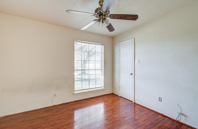 spare room with ceiling fan, a textured ceiling, and hardwood / wood-style flooring