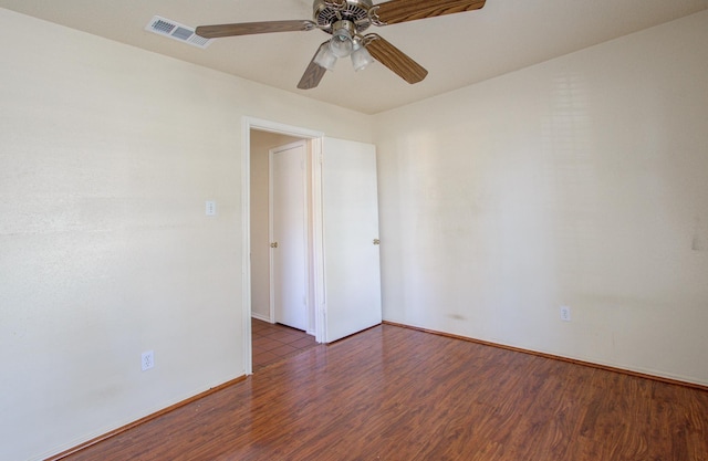 empty room featuring dark hardwood / wood-style floors and ceiling fan