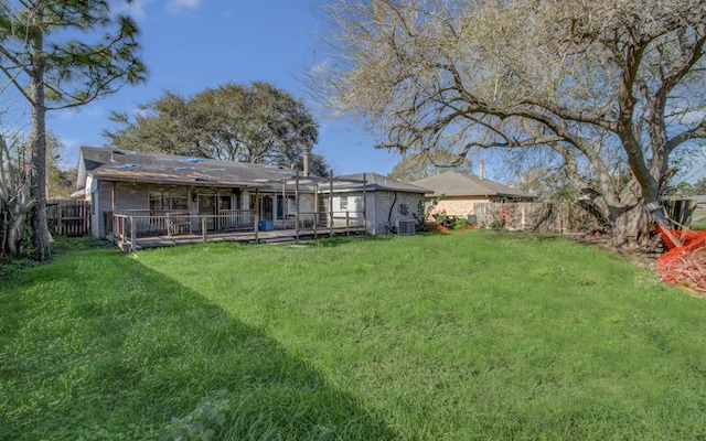 rear view of house featuring a lanai, a lawn, and central AC unit