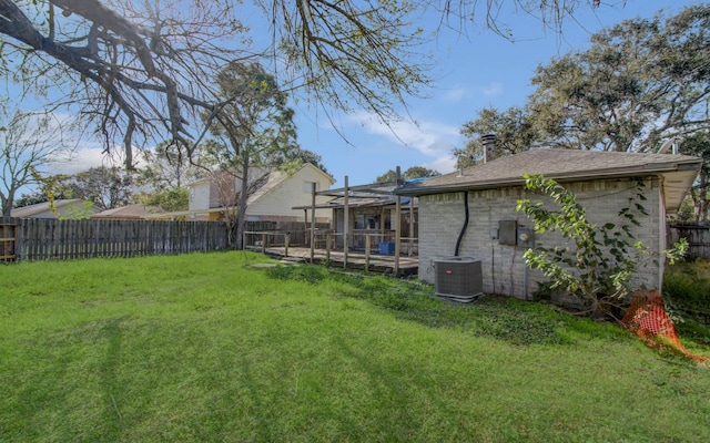 view of yard featuring a lanai and central AC