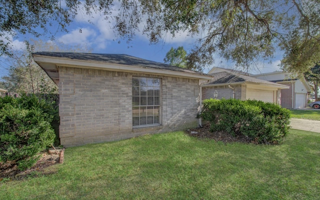 view of property exterior with a yard and a garage