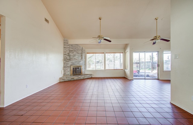 unfurnished living room featuring ceiling fan, light tile patterned floors, vaulted ceiling, and a brick fireplace