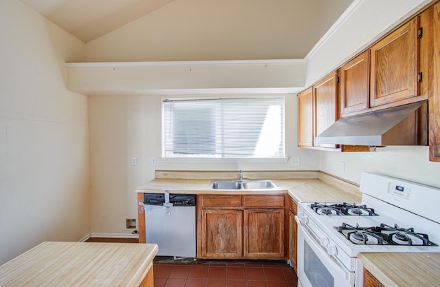 kitchen with white gas range oven, dark tile patterned floors, sink, dishwasher, and lofted ceiling