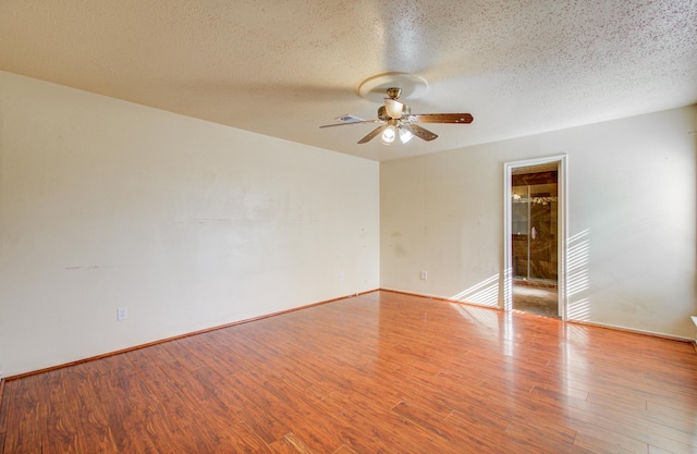 unfurnished room with light hardwood / wood-style floors and a textured ceiling