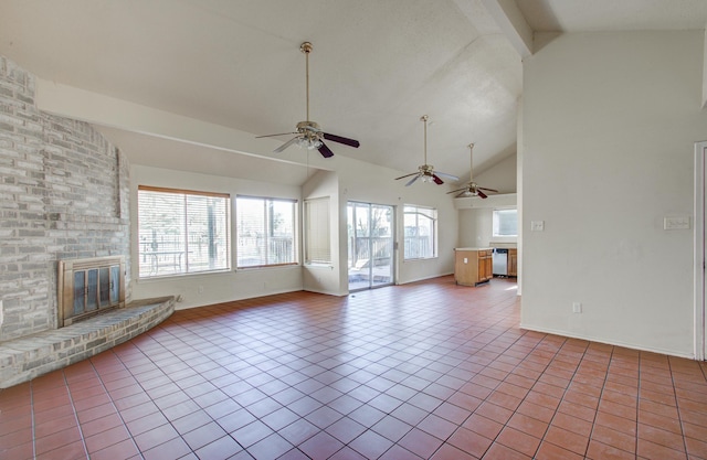 unfurnished living room featuring a fireplace, light tile patterned floors, vaulted ceiling with beams, and plenty of natural light