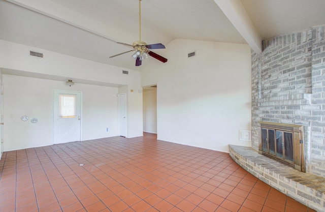 unfurnished living room featuring vaulted ceiling with beams, ceiling fan, tile patterned flooring, and a brick fireplace