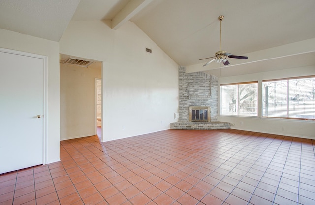 unfurnished living room with ceiling fan, lofted ceiling with beams, light tile patterned floors, and a brick fireplace