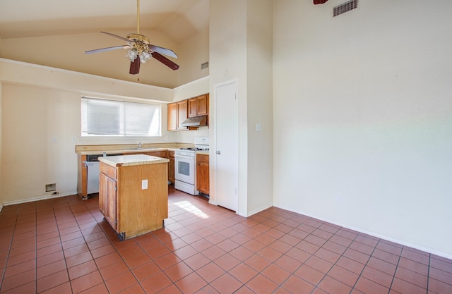 kitchen with a center island, tile patterned floors, sink, ceiling fan, and white range with gas stovetop