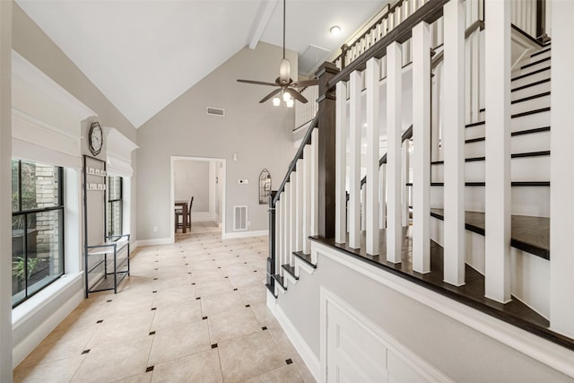 foyer entrance featuring ceiling fan, beam ceiling, light tile patterned floors, and high vaulted ceiling