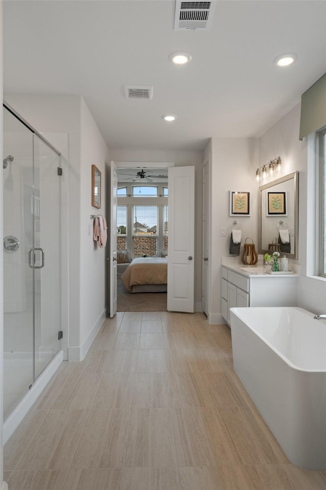 bathroom featuring vanity, ceiling fan, and plus walk in shower