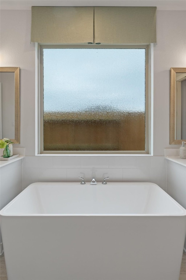 bathroom featuring a tub to relax in