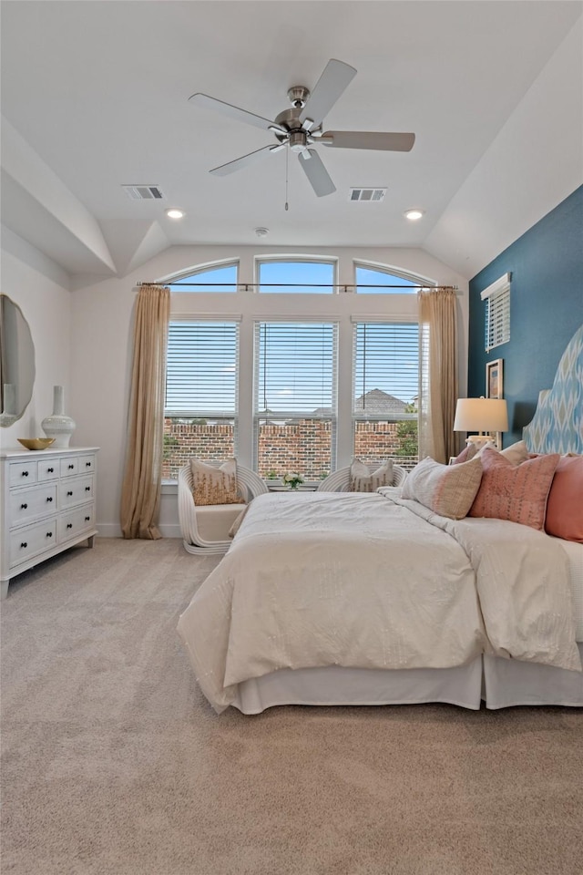 bedroom with multiple windows, ceiling fan, and lofted ceiling