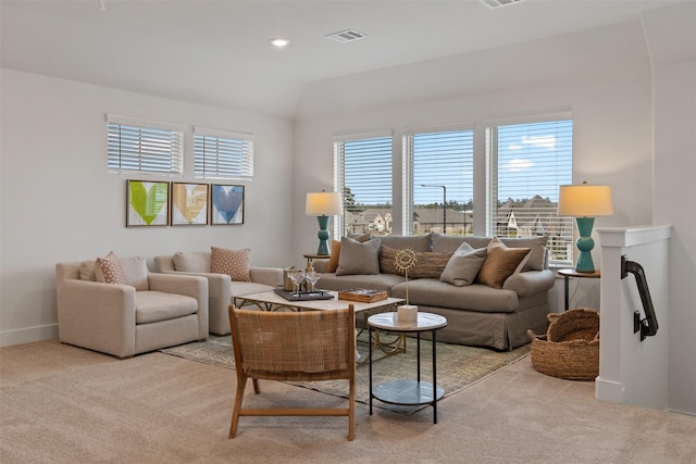 living room with lofted ceiling and light carpet