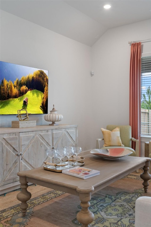 sitting room featuring vaulted ceiling