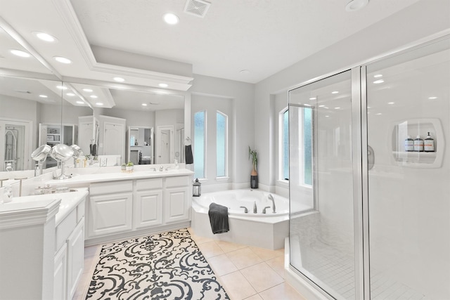 bathroom with tile patterned flooring, vanity, and shower with separate bathtub