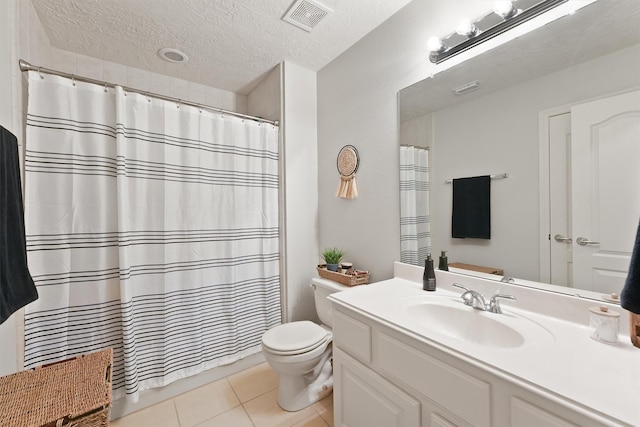 bathroom featuring vanity, tile patterned flooring, a shower with shower curtain, toilet, and a textured ceiling