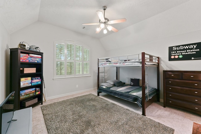 carpeted bedroom featuring a textured ceiling, ceiling fan, and lofted ceiling