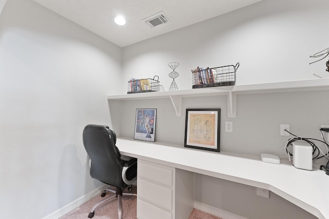 carpeted office featuring built in desk