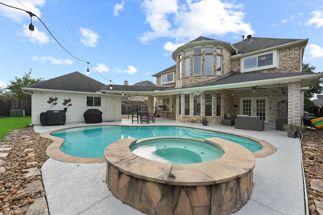 view of swimming pool featuring an outdoor hangout area, an in ground hot tub, a patio, and french doors