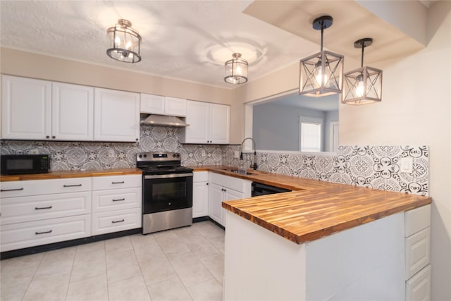 kitchen featuring wood counters, sink, white cabinets, stainless steel electric range oven, and hanging light fixtures