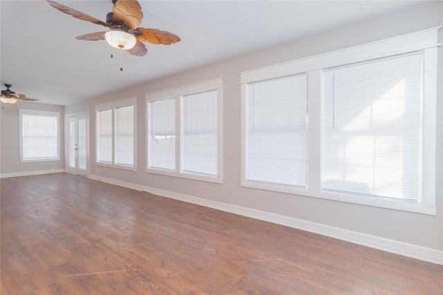 unfurnished sunroom with ceiling fan and a healthy amount of sunlight