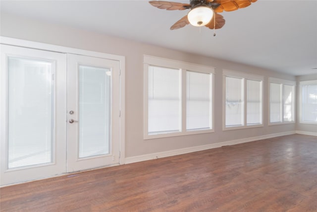 unfurnished sunroom with ceiling fan and french doors