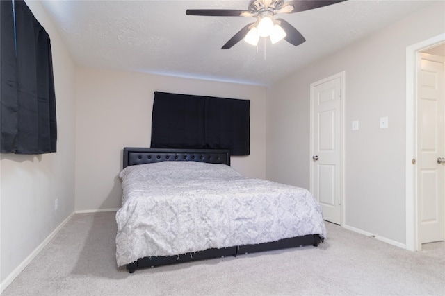 bedroom with carpet flooring, ceiling fan, and a textured ceiling