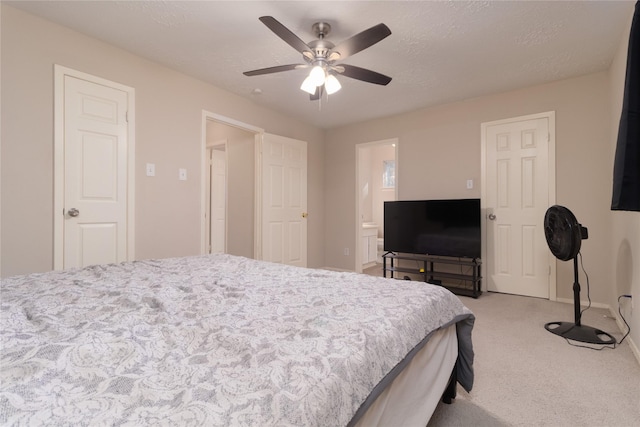 bedroom featuring carpet flooring, ceiling fan, and a textured ceiling